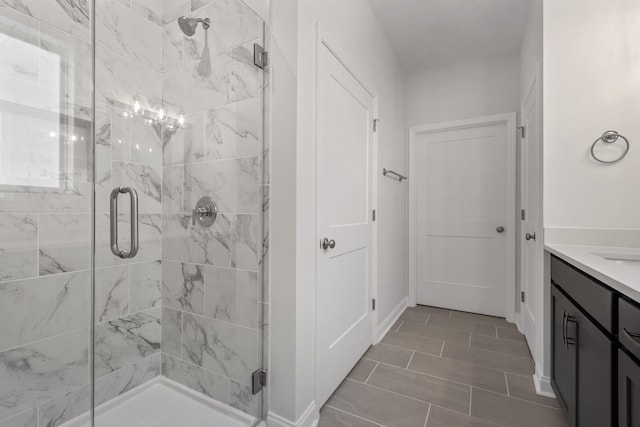 bathroom with vanity and a shower with shower door