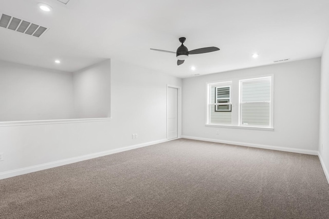 carpeted spare room with ceiling fan