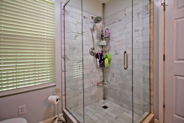 bathroom featuring a shower with shower door