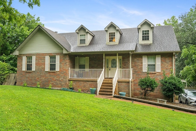 view of front of property with a front yard and covered porch