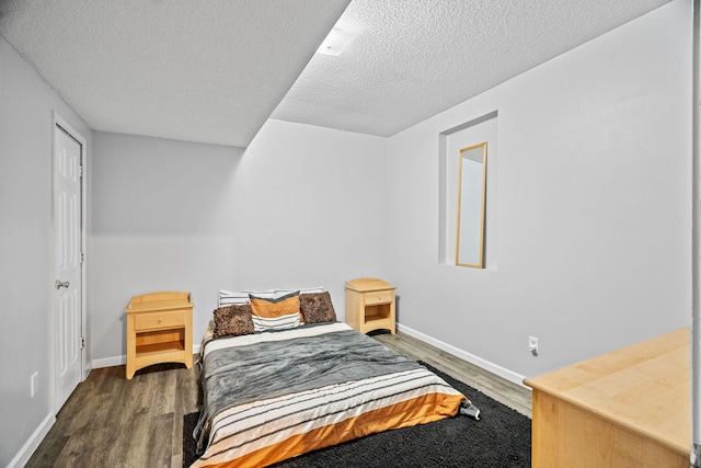 bedroom featuring dark hardwood / wood-style floors and a textured ceiling