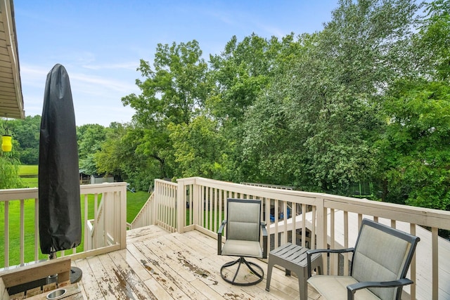 wooden terrace with a yard