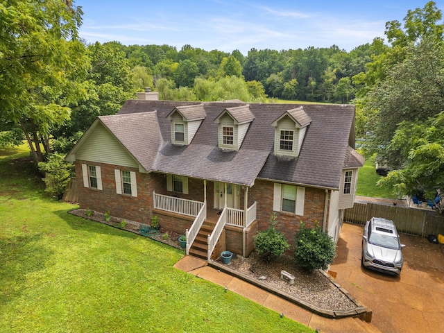 cape cod home featuring central AC, a porch, and a front lawn