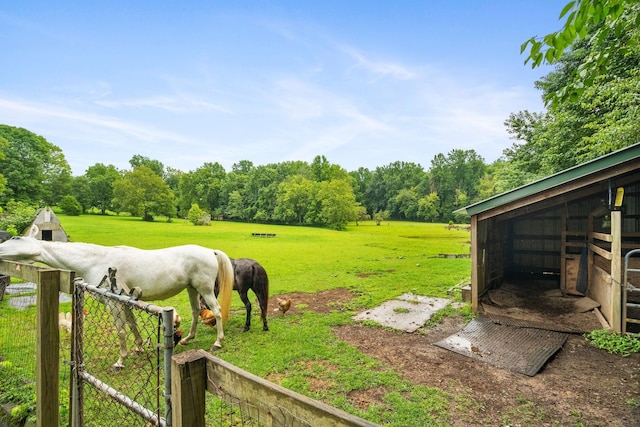 view of yard featuring a rural view and an outdoor structure