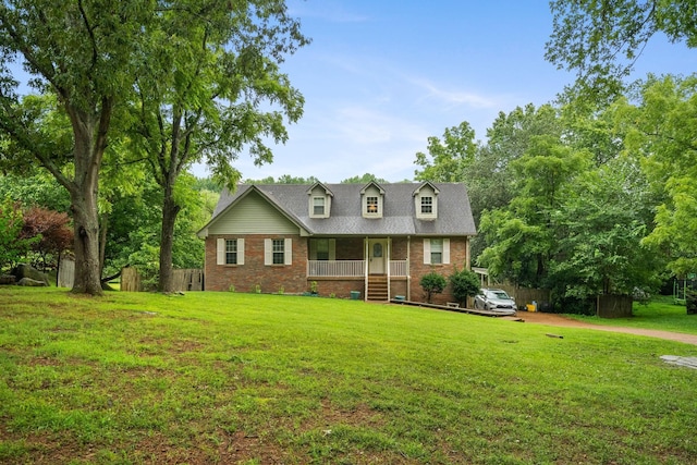 cape cod home featuring a porch and a front lawn