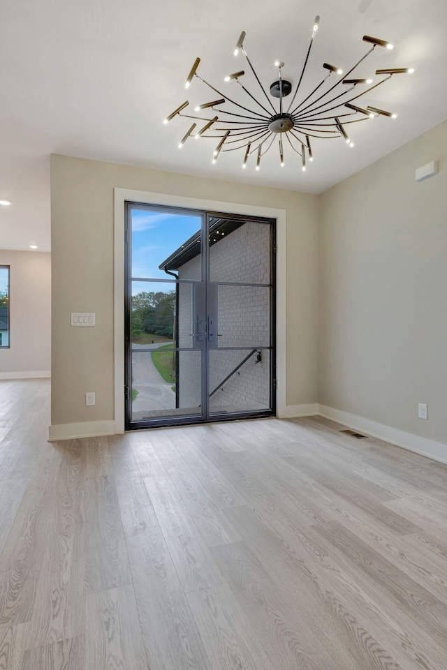 spare room featuring light hardwood / wood-style flooring