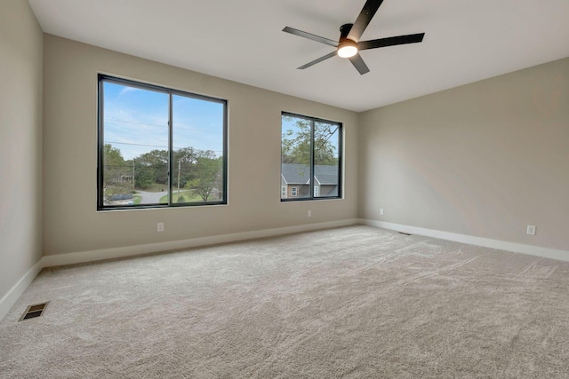 carpeted spare room with ceiling fan