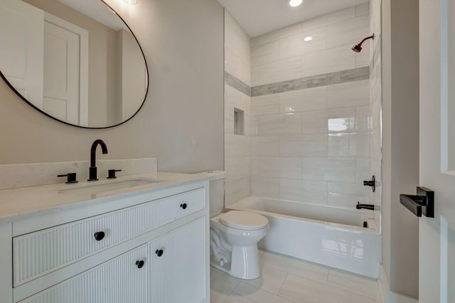 full bathroom with tiled shower / bath combo, vanity, tile patterned floors, and toilet