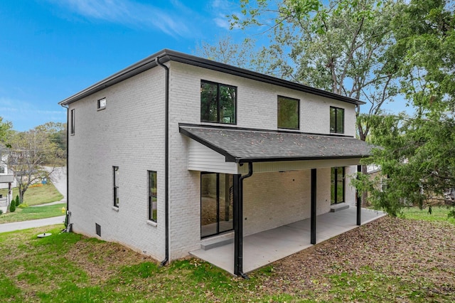 back of house featuring a yard and a patio