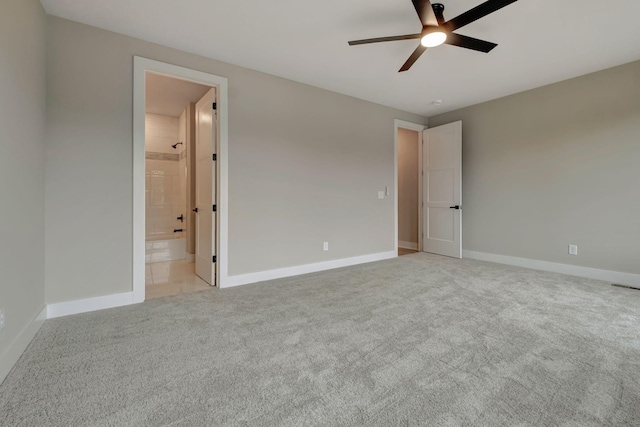 unfurnished bedroom with light carpet, ceiling fan, and ensuite bath