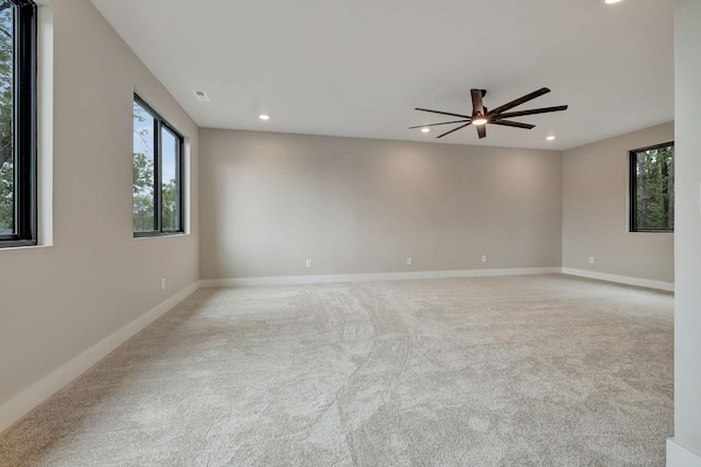 carpeted empty room featuring ceiling fan