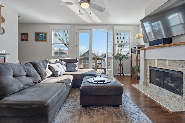 living room with ceiling fan, dark hardwood / wood-style floors, and a fireplace