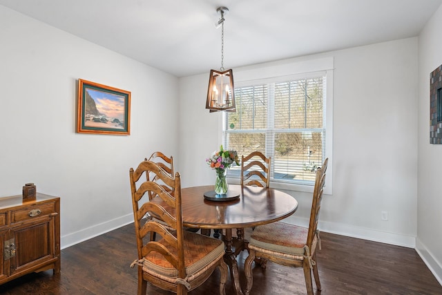 dining room featuring a notable chandelier and dark hardwood / wood-style flooring