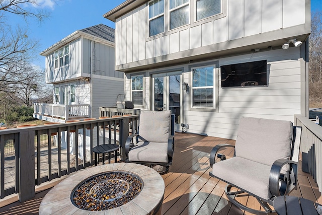 wooden terrace with an outdoor fire pit