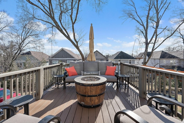 wooden terrace featuring a fire pit