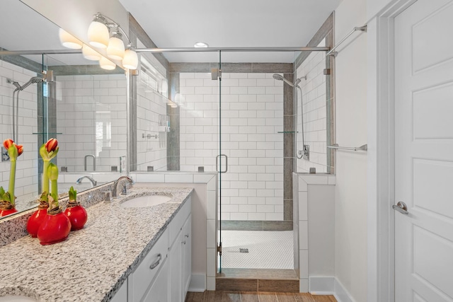 bathroom with vanity and a shower with door