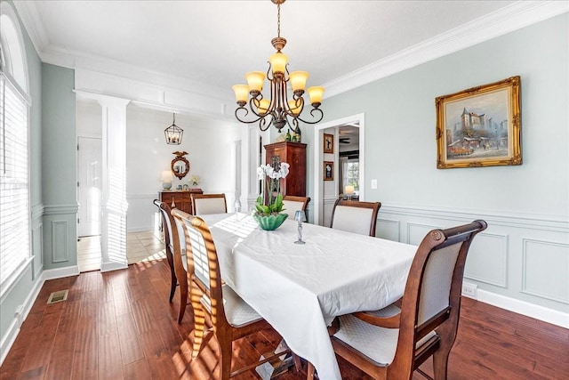 dining space with dark wood-type flooring, a healthy amount of sunlight, and decorative columns