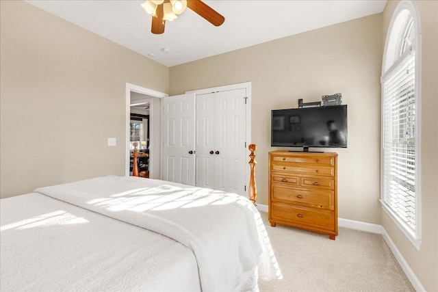 carpeted bedroom with a closet and ceiling fan