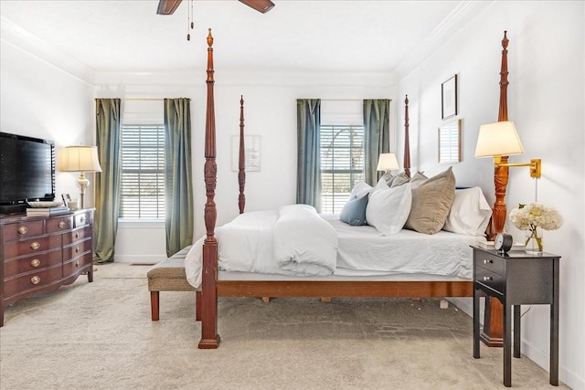 carpeted bedroom with multiple windows, ornamental molding, and ceiling fan