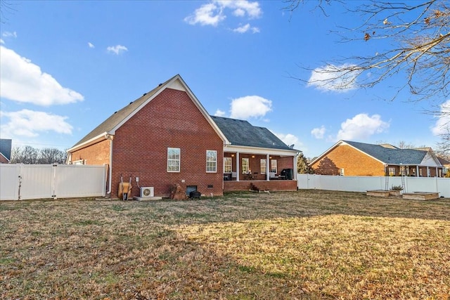 rear view of house with a lawn