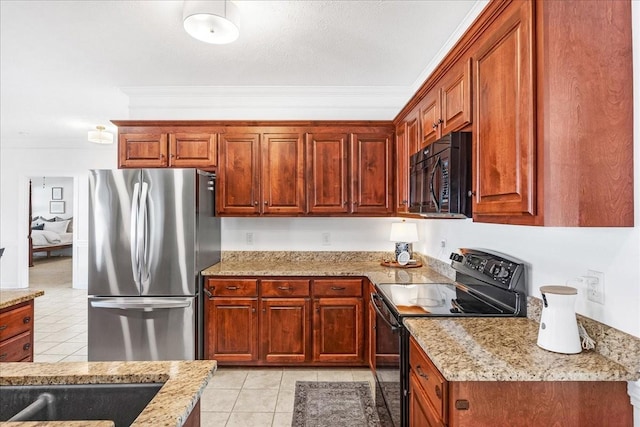 kitchen with ornamental molding, light stone countertops, light tile patterned floors, and black appliances