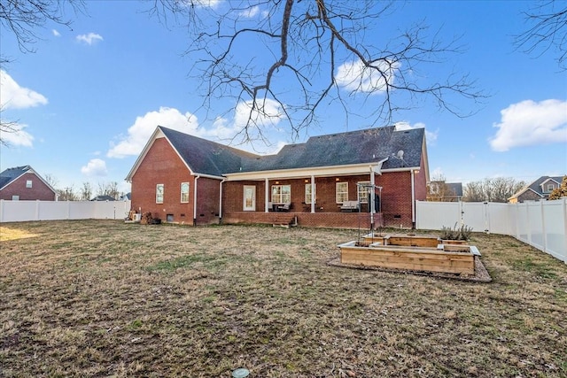 rear view of property with a yard