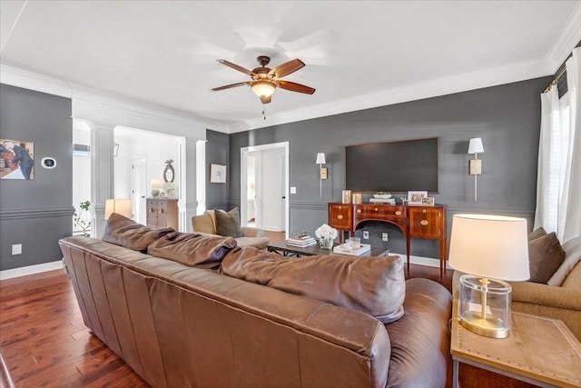 living room featuring crown molding, dark hardwood / wood-style floors, ceiling fan, and ornate columns