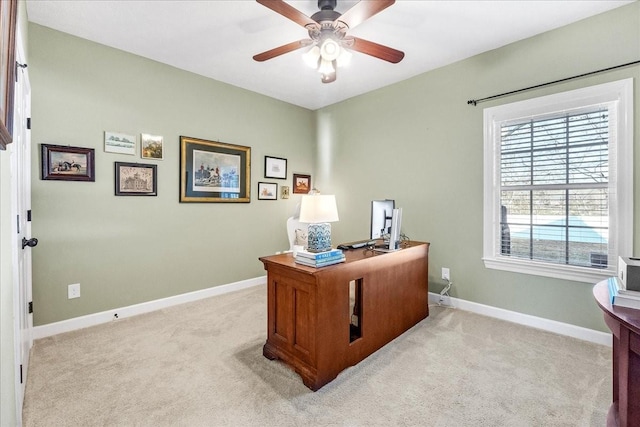 carpeted office space featuring ceiling fan