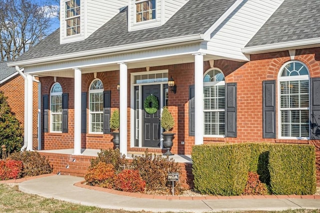 view of exterior entry with covered porch