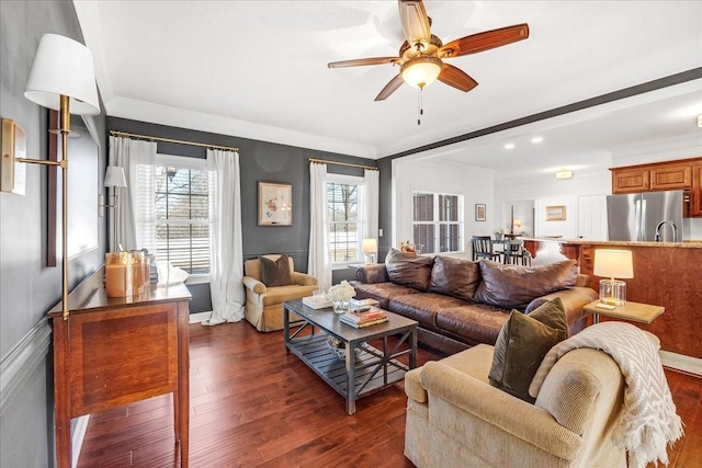 living room with ceiling fan, ornamental molding, and dark hardwood / wood-style floors