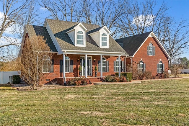 cape cod home with a front yard and covered porch