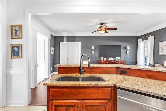 kitchen with sink, crown molding, stainless steel dishwasher, and ceiling fan