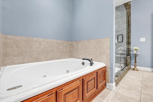 bathroom featuring tile patterned flooring and separate shower and tub