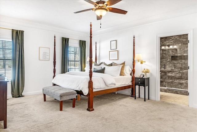 carpeted bedroom with crown molding, ensuite bath, and ceiling fan