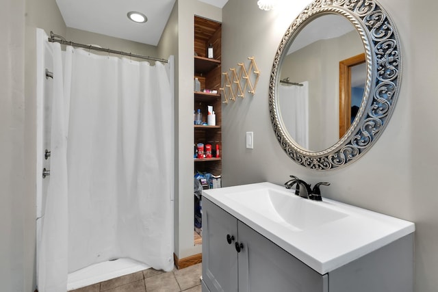 bathroom with a shower with shower curtain, vanity, and tile patterned flooring