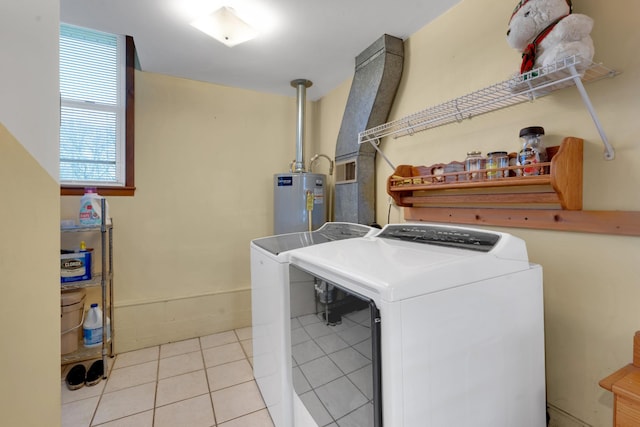 clothes washing area with separate washer and dryer, light tile patterned floors, and water heater