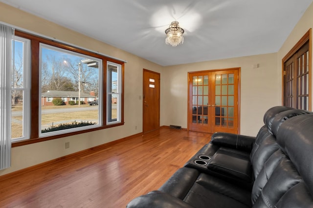 living room with french doors and light hardwood / wood-style floors