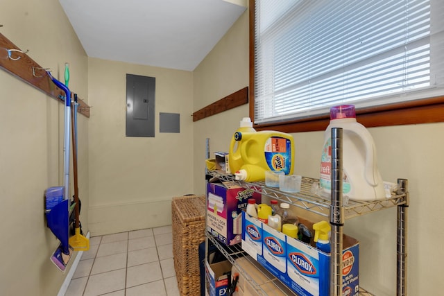 clothes washing area with light tile patterned floors and electric panel