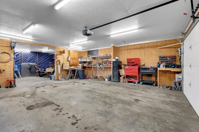 garage featuring a garage door opener and a workshop area