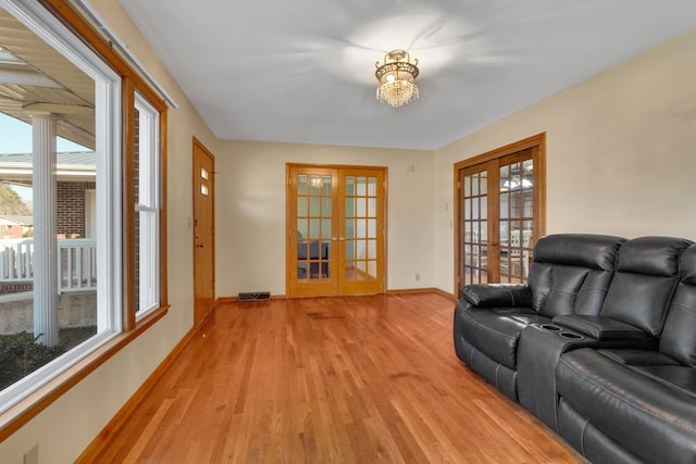 sitting room featuring light hardwood / wood-style floors and french doors