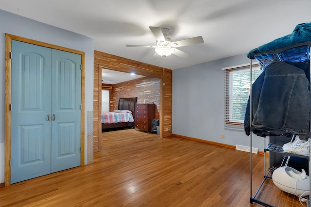 unfurnished bedroom with hardwood / wood-style flooring, a closet, and ceiling fan