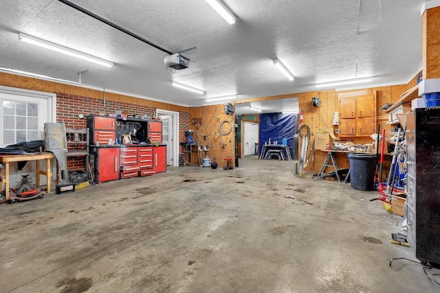 garage with a garage door opener and a workshop area