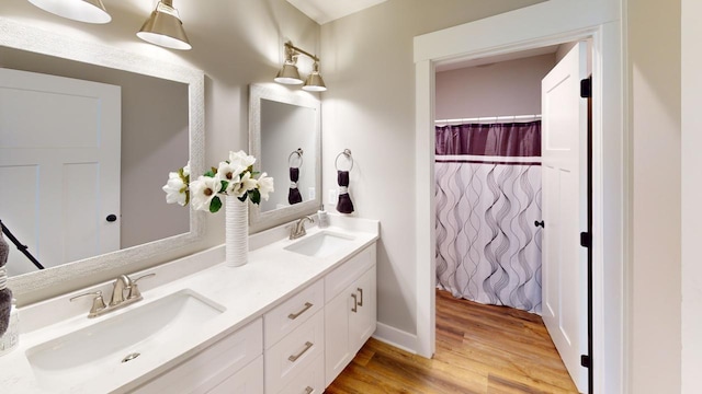 bathroom with vanity and hardwood / wood-style floors