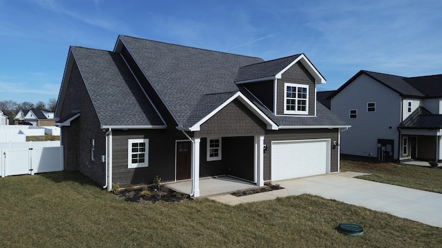 view of front of house featuring a garage and a front yard