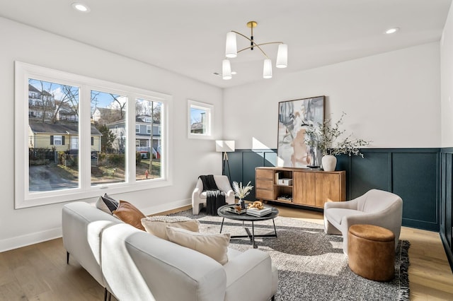 living room with an inviting chandelier and wood-type flooring