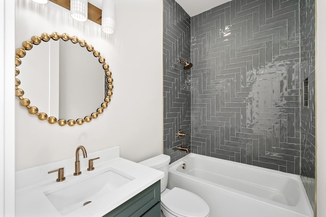 full bathroom featuring tiled shower / bath, vanity, and toilet