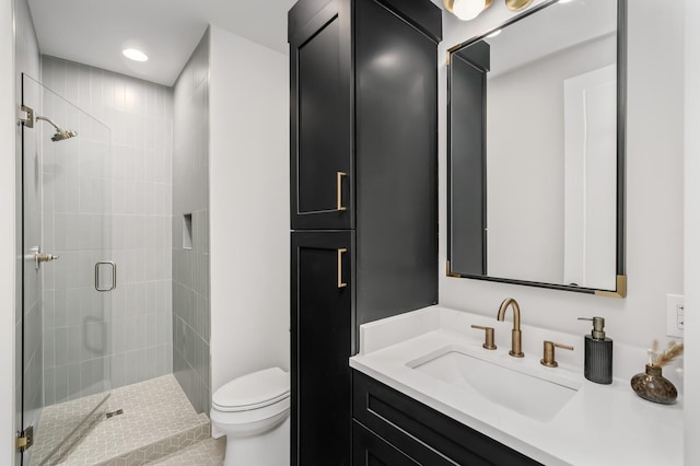 bathroom featuring walk in shower, vanity, and toilet