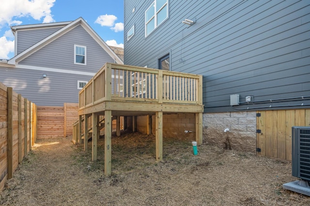 rear view of property featuring a wooden deck and central air condition unit