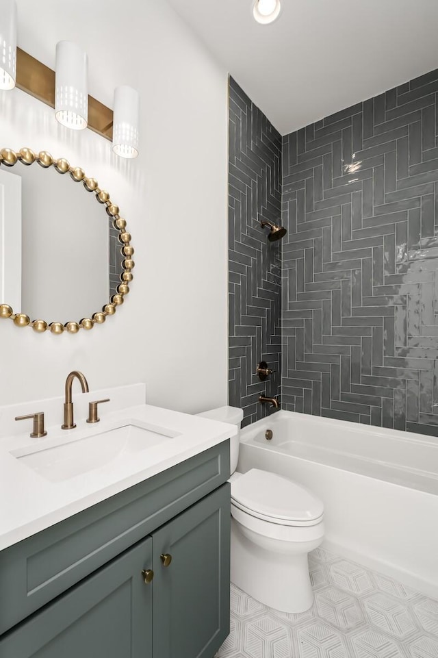 full bathroom featuring tiled shower / bath combo, vanity, and toilet