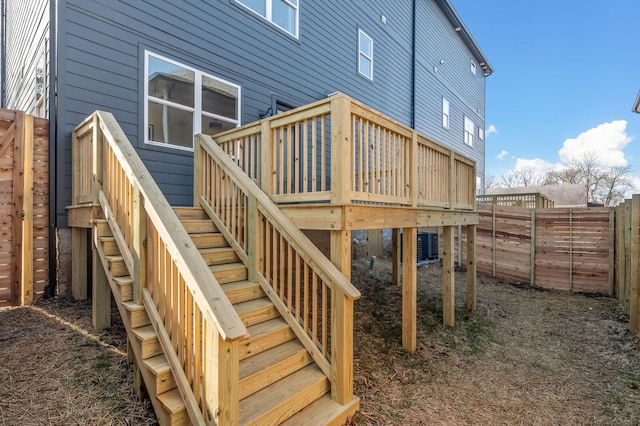 back of house featuring a deck and central air condition unit